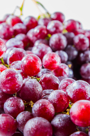 fresh red grape with water drop on white backgroundの写真素材