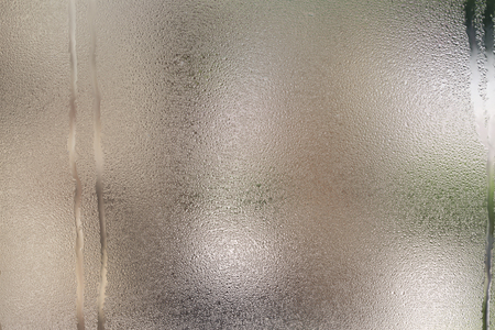 Drops of water on glass with green backgroundの写真素材