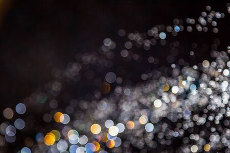 Colorful blur bokeh defocused on black backgroundの写真素材