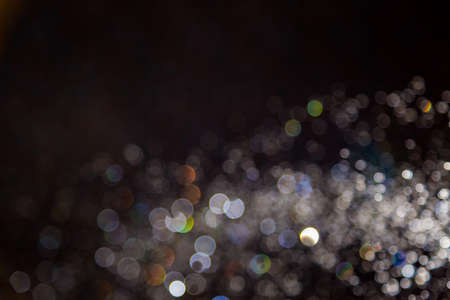 Colorful blur bokeh defocused on black backgroundの写真素材