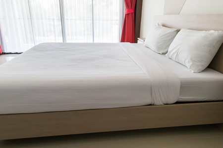 Beautiful white clean and modern bedroom  with glass doorの写真素材