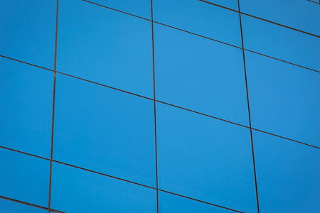 Modern office building with blue glass window background