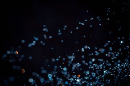 Abstract bokeh  texture on black backgroundの写真素材