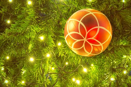 Decorative Christmas balls and Christmas tree with light backgroundの写真素材