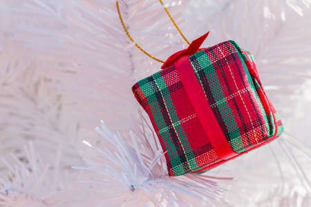 Red gift box on Christmas tree backgroundの写真素材