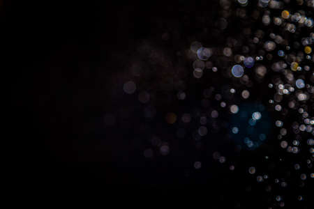 Colorful blur bokeh defocused on black backgroundの写真素材