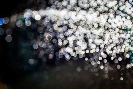 Colorful blur bokeh defocused on black backgroundの写真素材