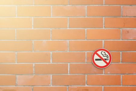 No smoking sign on red brick backgroundの写真素材