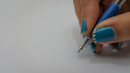 Close-up of woman hands with pens over empty documents backgroundの写真素材