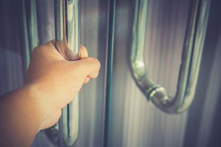 Man hand prepare to open the door to entering an Office backgroundの写真素材