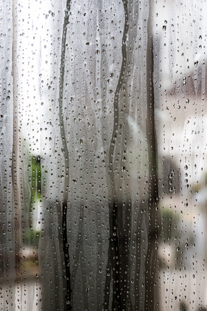 Water drop on the glass of windows backgroundの写真素材