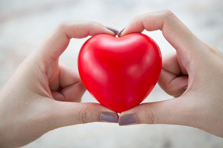 Woman hold red heart use for backgroundの写真素材