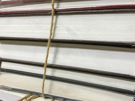 Pile of old books with rope backgroundの写真素材
