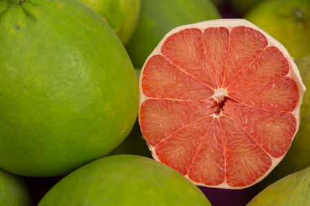 Green fresh red grapefruit slice organic nature backgroundの写真素材