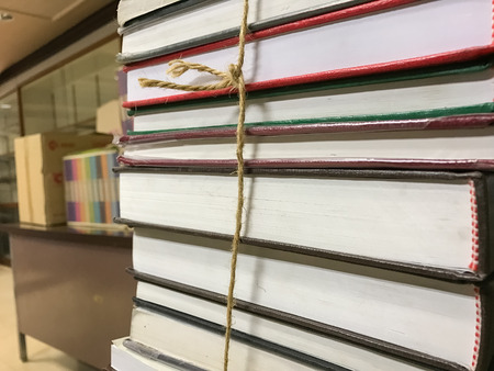 Pile of old books with rope backgroundの写真素材
