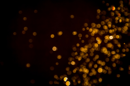 Defocus bokeh glitter gold vintage lights dark backgroundの写真素材