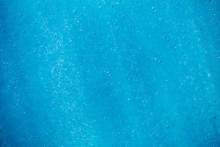 abstract blue and white bokeh and bubbles in the water backgroundの写真素材