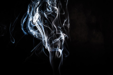 Abstract smoke swirls on black backgroundの写真素材