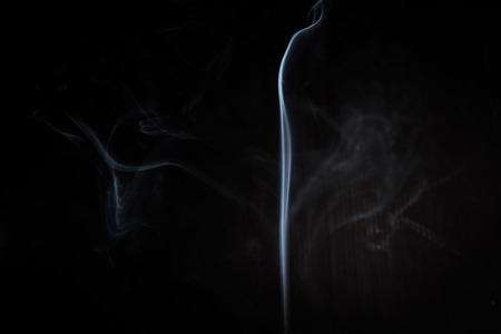 Abstract smoke swirls on black backgroundの写真素材