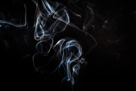 Abstract smoke swirls on black backgroundの写真素材