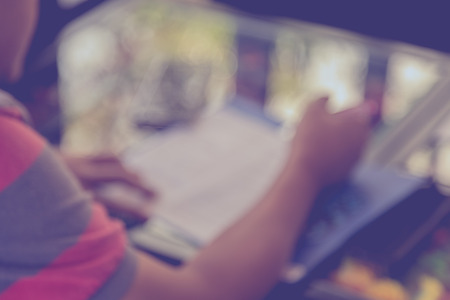 Blur image of man fill out application with camera and smart phone on the table backgroundの写真素材