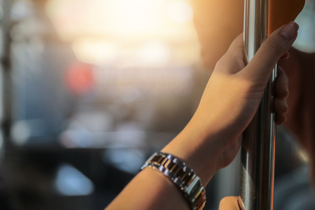Hand holding safety straps, Hanging handle, plastic grab handle inside the public transportの写真素材