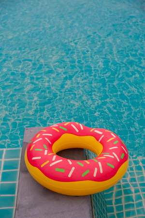Rubber ring in blue swimming pool background