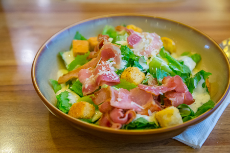 Bacon and ham salad for health on the wood tableの写真素材