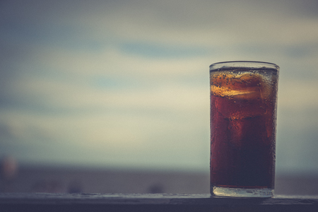 Cola with ice in the glass ready to drink for refresh on blur backgroundの写真素材