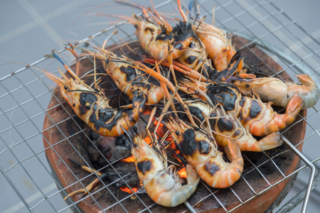 Fresh shrimp grilled bbq seafood on charcoal stove for partyの写真素材