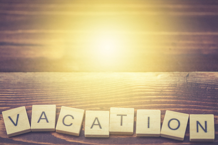 Alphabet Vacation on old vintage wood backgroundの写真素材