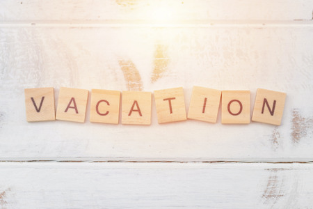 Alphabet Vacation on old vintage wood backgroundの写真素材
