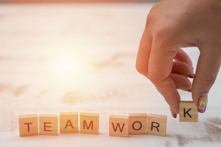 Alphabet Team work on old white vintage wood backgroundの写真素材