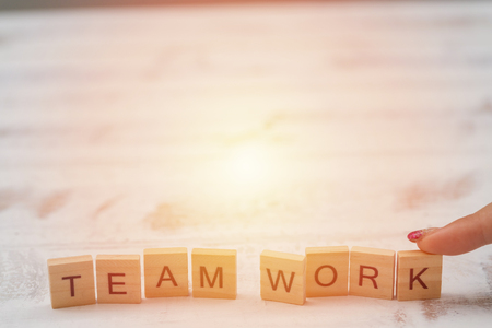 Alphabet Team work on old white vintage wood backgroundの写真素材