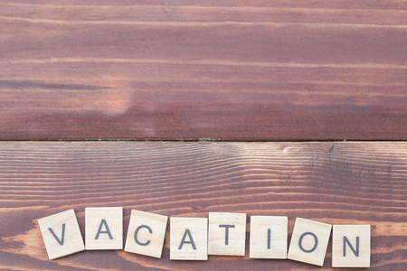 Alphabet Vacation on old vintage wood backgroundの写真素材