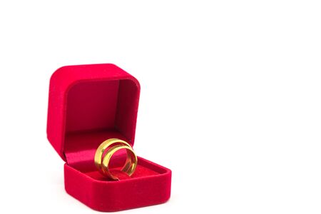 Wedding ring in red velvet box on white backgroundの写真素材