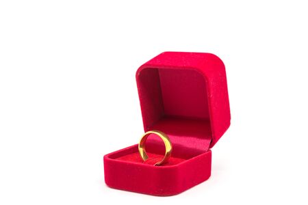 Wedding ring in red velvet box on white backgroundの写真素材