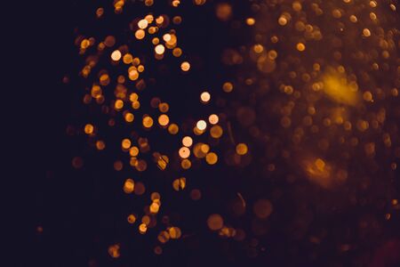 Abstract gold defocus bokeh glitter vintage lights with black backgroundの写真素材