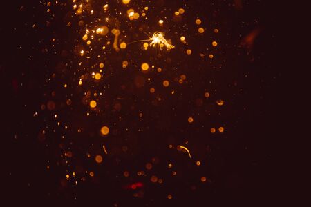 Abstract gold defocus bokeh glitter vintage lights with black backgroundの写真素材