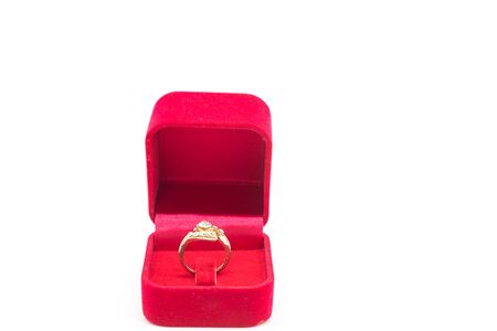 Wedding ring in red velvet box on white backgroundの写真素材