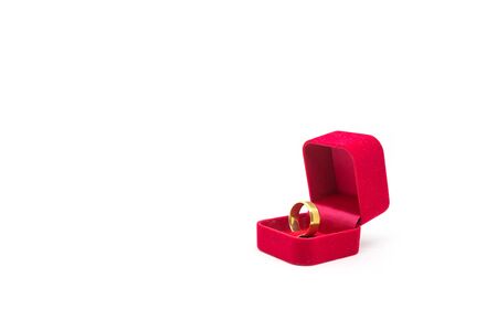 Wedding ring in red velvet box on white backgroundの写真素材