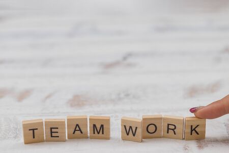 Alphabet Team work on old white vintage wood backgroundの写真素材