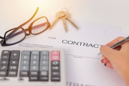 Sign a business contract with a key  backgroundの写真素材