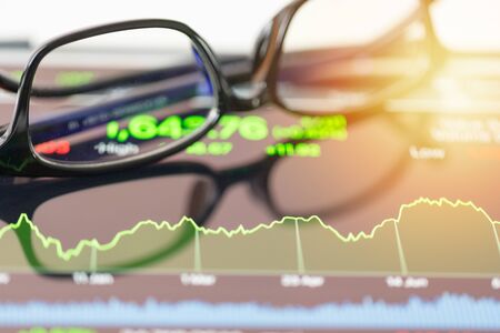 financial chart stock trading seen by unfocused glasses backgroundの写真素材