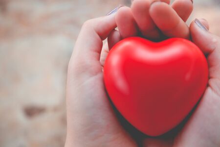 Woman hold red heart use for backgroundの写真素材