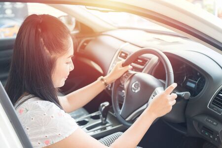 Beautiful Asian woman likes to drive a car that is happy