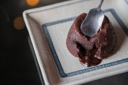 Chocolate cupcake with dark chocolate icing bakeh backgroundの写真素材