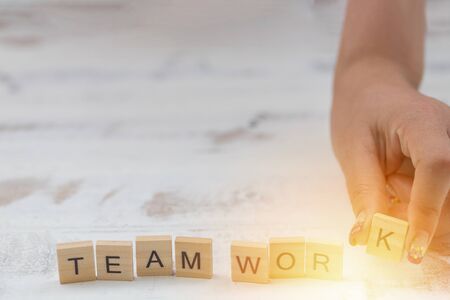 Alphabet Team work on old white vintage wood backgroundの写真素材