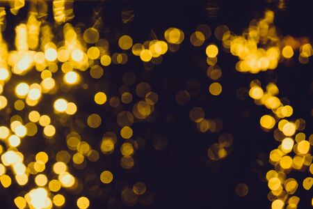 Abstract gold bokeh with black backgroundの写真素材