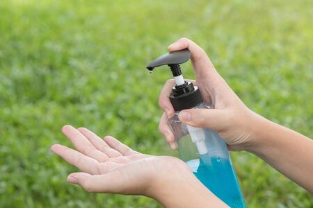 Close up hand is pressing the alcohol gel to prevent the Covid-19 virusの写真素材